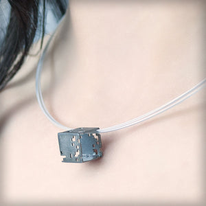 Necklace with small black cube